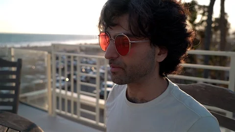 Man Drinking Coffee with Statue Stock Footage 99480429