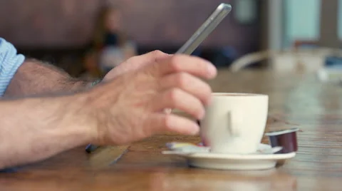 Man drinking coffee in trendy coffee shop, while checking his tablet Stock Footage 63018430
