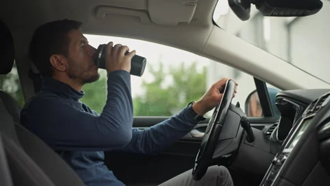Man drinking coffee while driving car Stock Footage 340490119