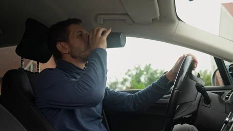 Man drinking coffee while sitting in car Stock Footage 340133480