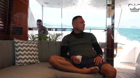 Man drinking coffee while traveling on a luxury yacht Video stock 315880337