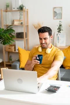 Man drinking coffee while working at home. Stock Photos