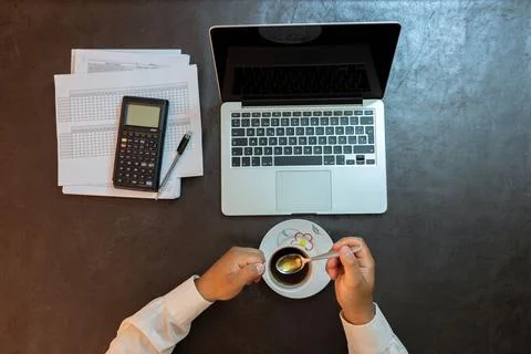 Man drinking coffee while working from home, aerial view Stock Photos