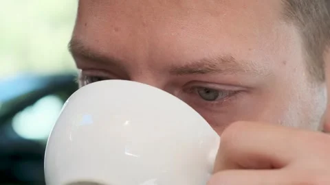 Man drinking cup of coffee cappuccino or latte outdoors in coffee house Stock Footage 252767648