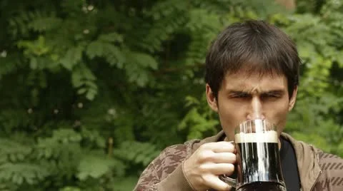 Man drinking a dark beer Stock Footage 11291379