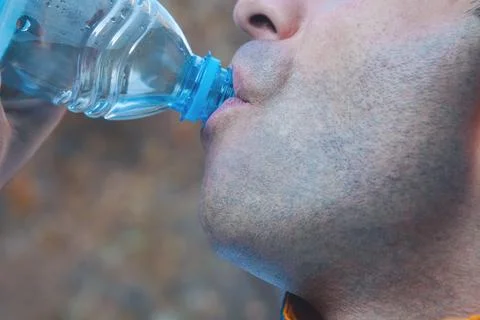 Man drinking a drink in the park Stock Photos