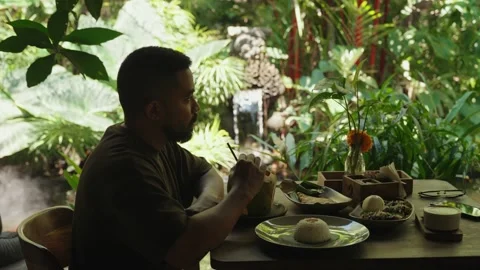 Man Drinking Fresh Coconut Drink Lush Tropical Garden Bali, Indonesia Видео 346832533