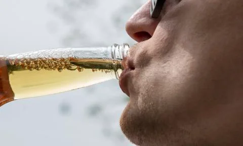 Man drinking fresh cold beer in nature Stock Photos