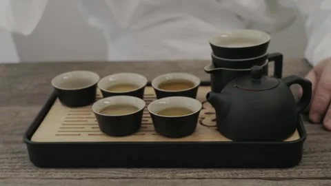 Man drinking green tea from Chinese tea set Stock Footage 323164335