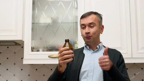 Man drinking healthy kombucha tea at home, thumbs up Stock Footage 221427722
