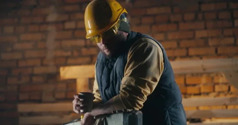 Man drinking hot beverage on construction site Vídeos de archivo 152128756