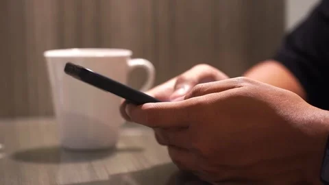 Man drinking hot coffee from white mug sitting at the table Stock Footage 337208479