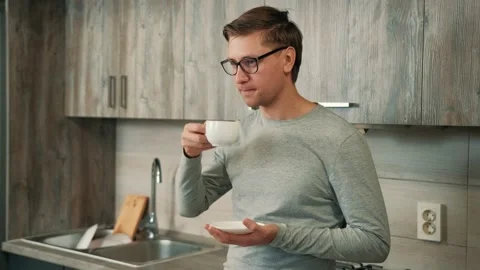 Man is drinking hot strong coffee from a white cup while take a break from work. Stock Footage 144614539