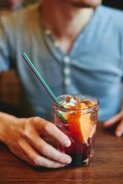 Man drinking lemonade in cafe restaurant holding glass cocktail Stock Photos