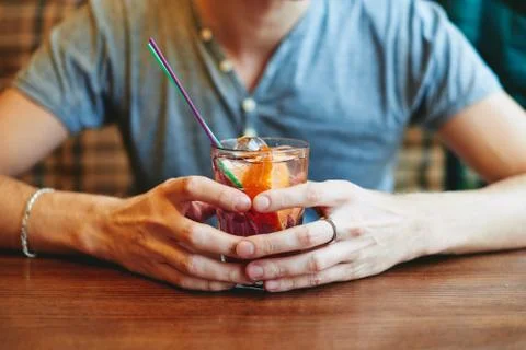 Man drinking lemonade in cafe restaurant holding glass cocktail Stock Photos