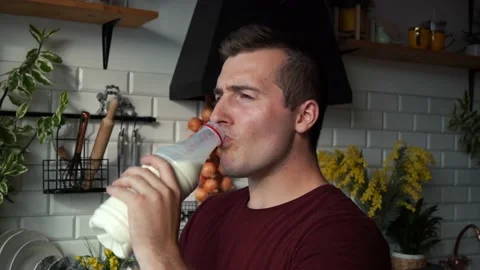 Man drinking milk in the kitchen Video stock 157582239