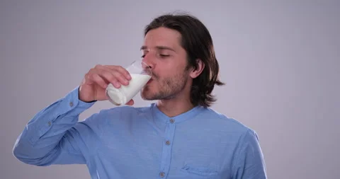 Man drinking milk over white background Stock Footage 141511590