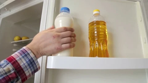 The man is drinking milk from the refrigerator Stock Footage 72530324