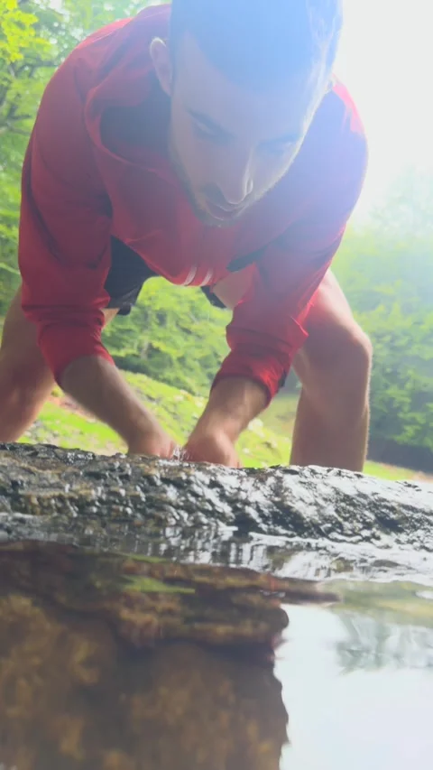 Man drinking from a natural spring. Stock Footage 283288717