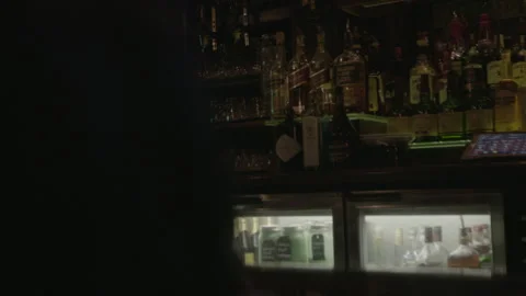 Man Drinking Pint of Beer at Dimly Lit Bar Counter Stock Footage 343950809