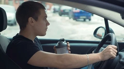Man drinking protein shake after workout in car. Stock Footage 69751312