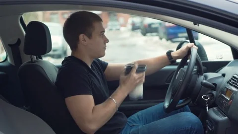 Man drinking protein shake in car. Video stock 69751142