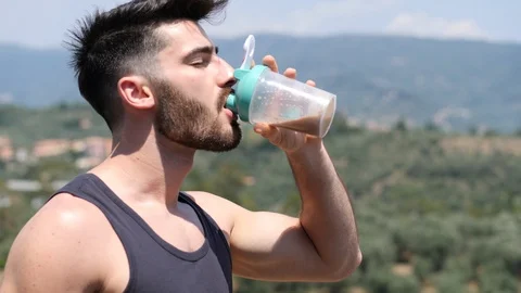 Man drinking protein shaker from blender Stock Footage 91310018
