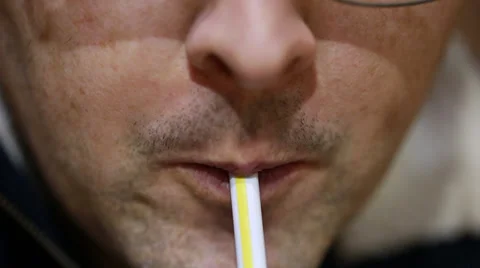 A man drinking soda from a straw Stock Footage 35518401