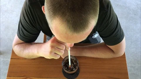 Man drinking soft drink cola in cafe. Soda. Top view. Bali island, Indonesia. Stock Footage 102487694