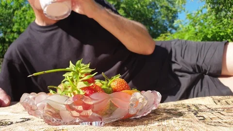 A man is drinking strawberry yogurt. Stock Footage 111140425