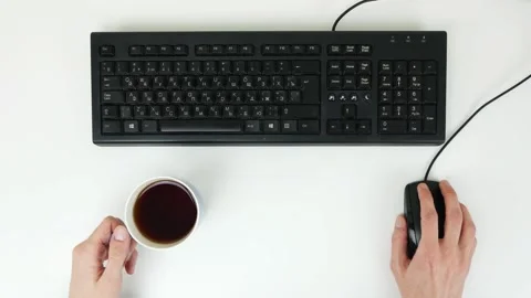 Man drinking tea and surfing the internet on a white table. Top view Stock Footage 101839661