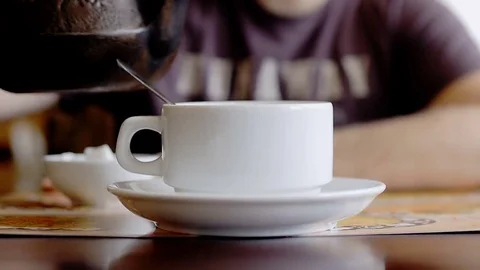 Man drinking tea in a cafe near the window. Video stock 73010701