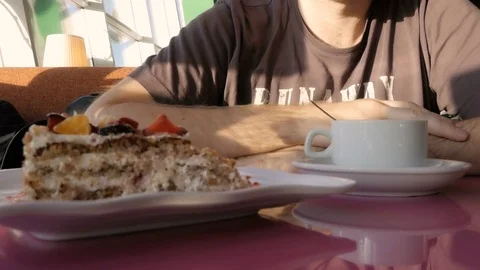 Man drinking tea in a cafe near the window. Eat cake Stock Footage 73015346
