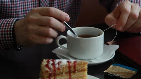 Man is drinking tea with cake in cafe Stock Footage 49761409