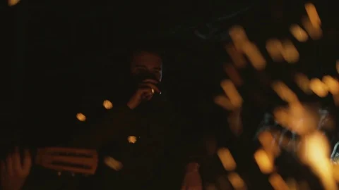 Man drinking tea by the fire Stock Footage 128918645