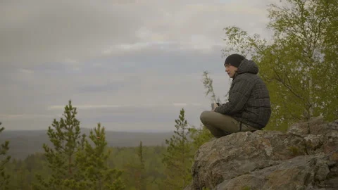 Man is drinking tea in the forest Stock Footage 91192964