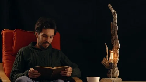 Man drinking tea next to the lamp Stock Footage 99956892