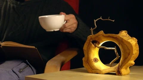 Man drinking tea next to the lamp Stock Footage 100656599