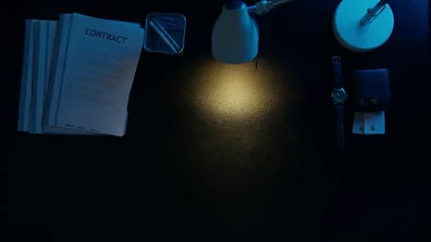 A man is drinking tea at the office table and uses his phone. Stock Footage 82165793