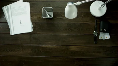 A man is drinking tea at the office table and reads a notepad. Stock Footage 82176080