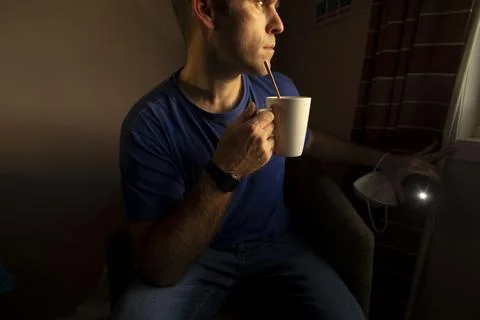 Man drinking tea, self isolate, whaiting results of a pcr test, UK Stock Photos
