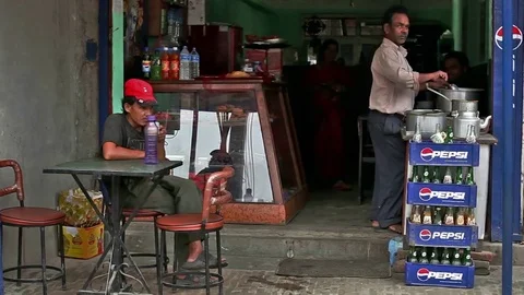 Man drinking tea in tea counter in Kathmandu Stock Footage 75575150