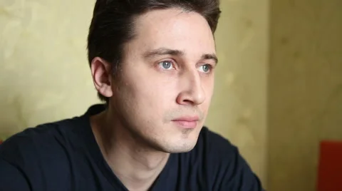 Man drinking tea while sitting at the kitchen table Stock Footage 60423320