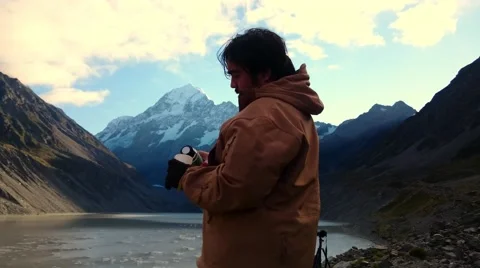 Man Drinking From Thermos While Enjoying Mountain  Scenery Video stock 64176603