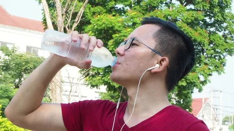 Man drinking water after jogging Stock Footage 89327620