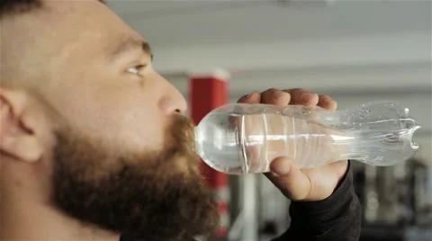 Man drinking water after workout in the gym Stock Footage