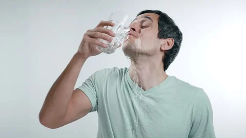 Man Drinking Water and Accidentally Spilling It on Himself Stock Footage 295115572