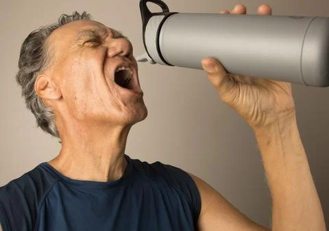 Man drinking from a water bottle after working out Stock Photos