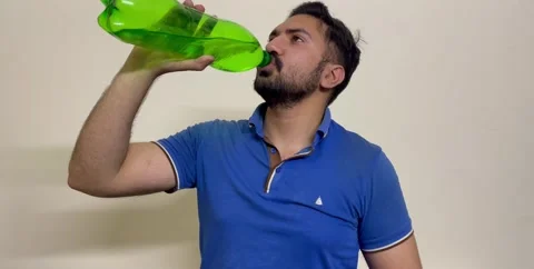 Man Drinking Water from bottle Young bearded fun fitness trainer instructor Stock Footage 241446568