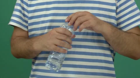 Man drinking water close-up, only hands appear Stock Footage 344588724